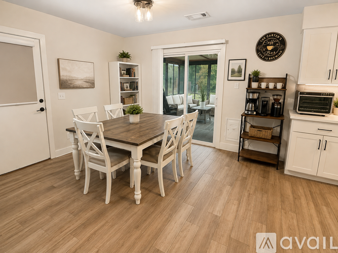 A dining room with a wooden table and chairs.