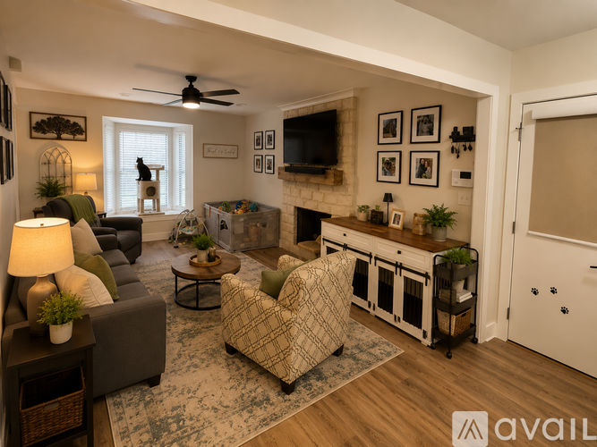 A living room with a couch, chair, and a fireplace.