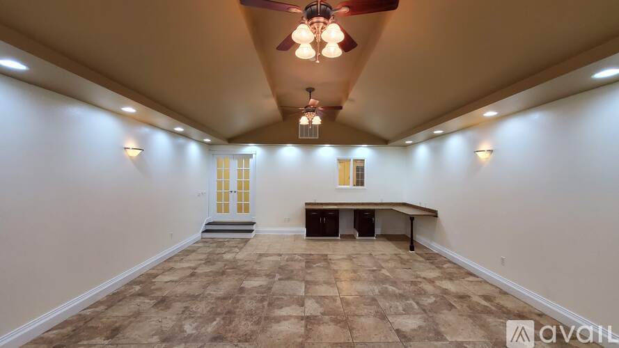 A spacious room with a checkered floor and a bench.