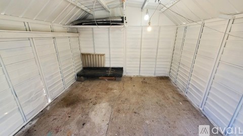 A spacious white storage unit with a black object in the middle.