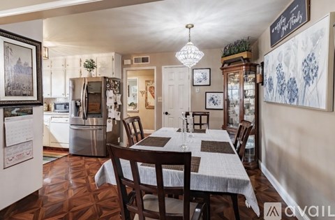 A dining room with a table set for six people.