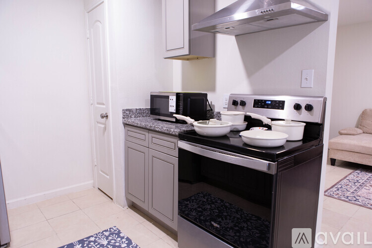 A modern kitchen with a stainless steel oven and microwave.