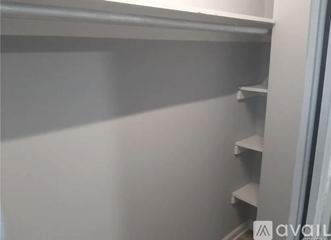 A white shelf with a few empty shelves on it.