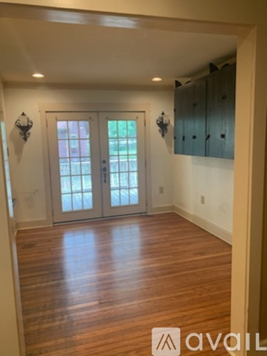 A room with wooden floors and a large glass door.