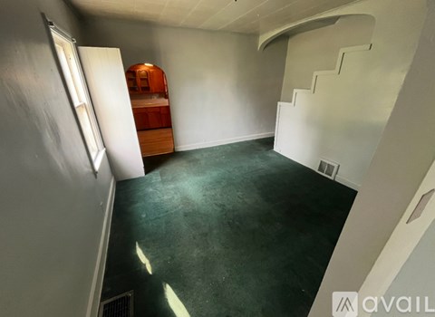 A room with a staircase and a bed in it.