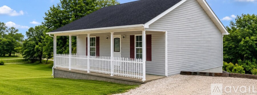 A small house with a porch and a gabled roof.