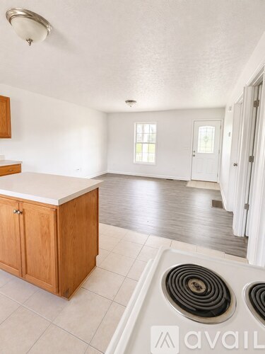 A kitchen with white cabinets and a white counter top.