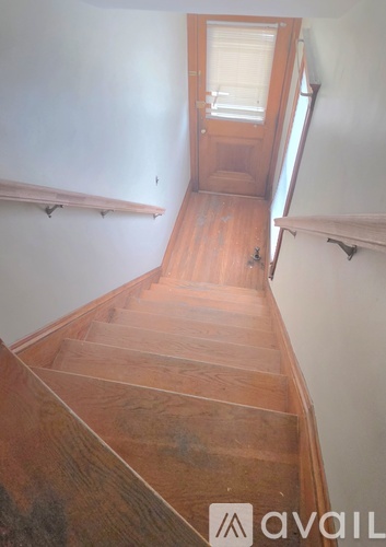A wooden staircase leading to a door.