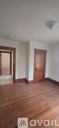 A room with wooden floors and a door.