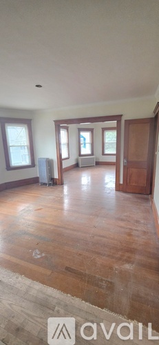 A room with wooden floors and a window.