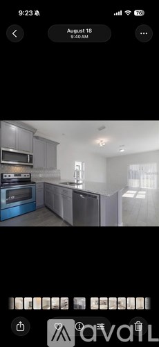 A modern kitchen with stainless steel appliances and a large island.