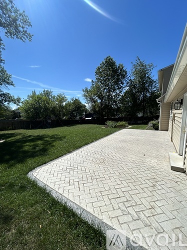 A paved walkway leads through a grassy area.