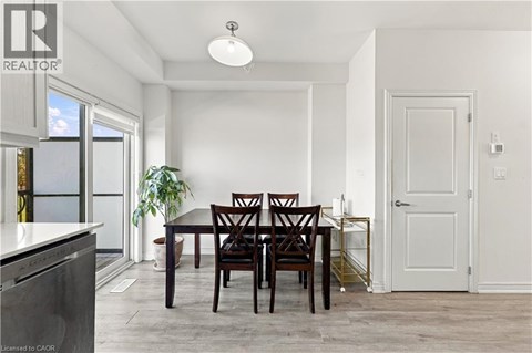 A dining room with a table and chairs.