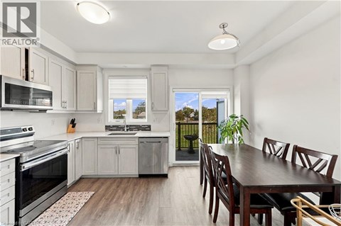 A kitchen with a dining table and chairs.