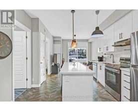 A modern kitchen with white cabinets and a large island.