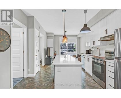 A modern kitchen with white cabinets and a large island.