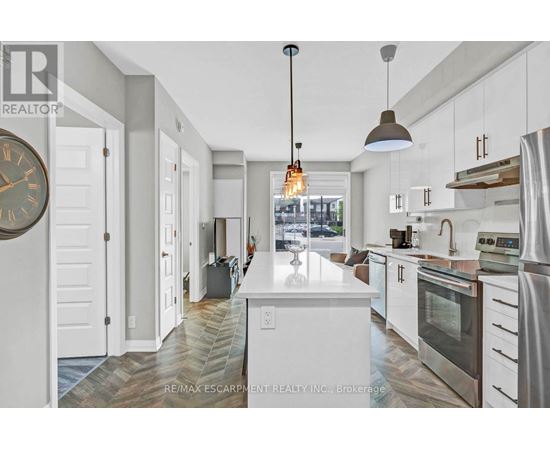 A modern kitchen with white cabinets and a large island.