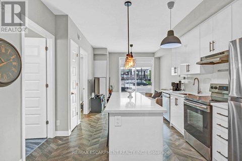 A modern kitchen with white cabinets and a large island.