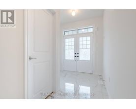 A white door with a glass window is in a room with white walls.