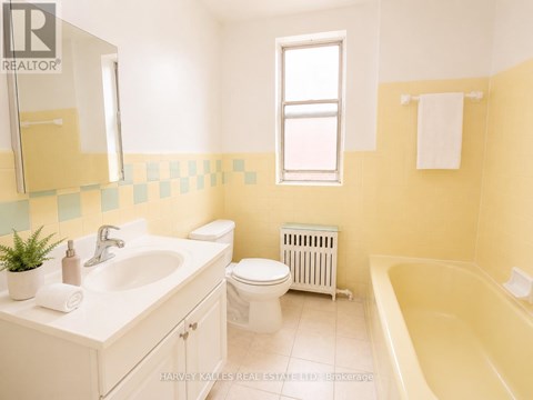 A bathroom with a white sink, toilet, and bathtub.