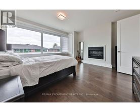 A bedroom with a large bed and a fireplace.