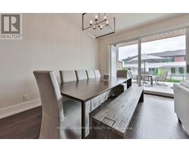 A modern dining room with a wooden table and chairs.