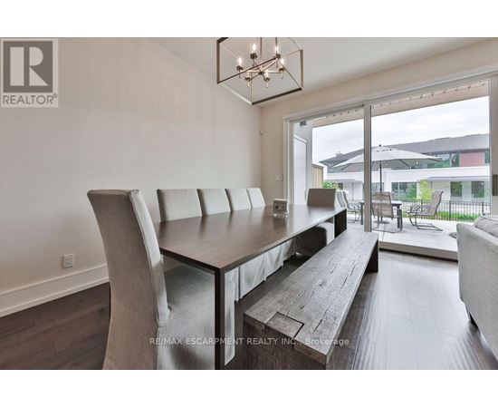 A modern dining room with a wooden table and chairs.