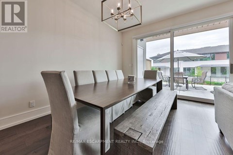 A modern dining room with a wooden table and chairs.