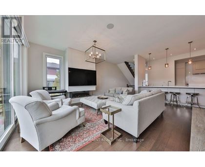A modern living room with a white sofa set and a wooden coffee table.