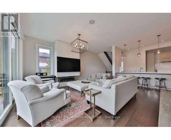A modern living room with a white sofa set and a wooden coffee table.