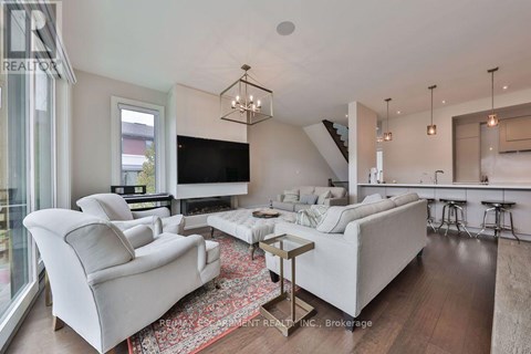 A modern living room with a white sofa set and a wooden coffee table.