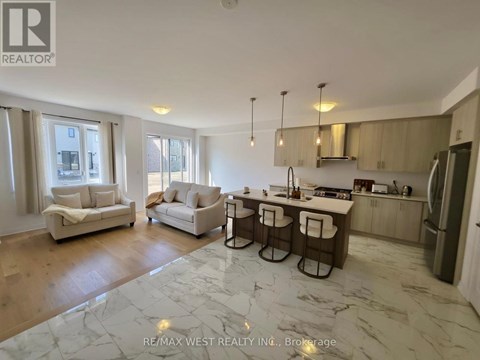A spacious kitchen and living room with a marble floor.
