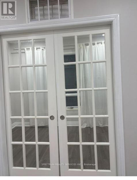 A white double door with glass panels and a window above it.