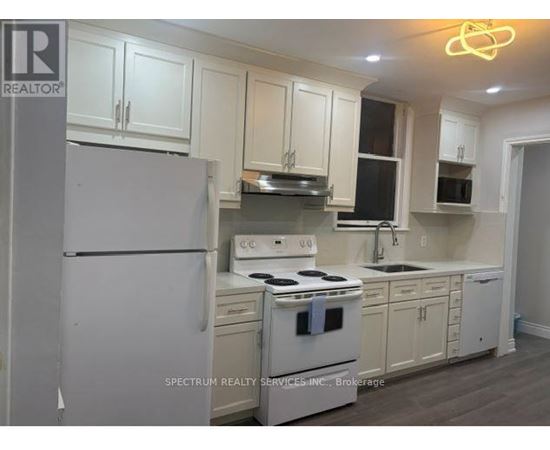 A kitchen with white appliances and cabinets.