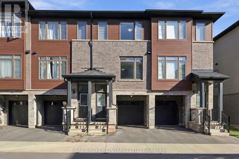 A multi-story residential building with a brick facade and multiple garage doors.