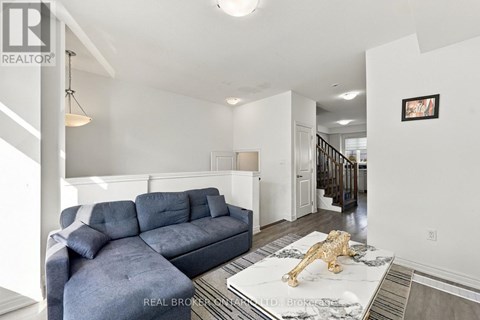 A living room with a grey couch and a gold lion statue on the coffee table.