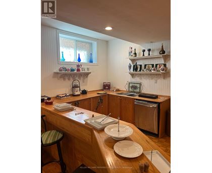 A kitchen with a wooden counter and white walls.
