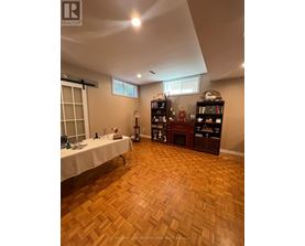 A room with wooden flooring and a table with a white cloth.