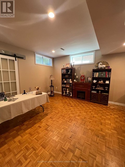 A room with wooden flooring and a table with a white cloth.