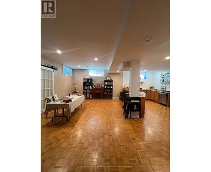 A living room with a wooden floor and furniture.