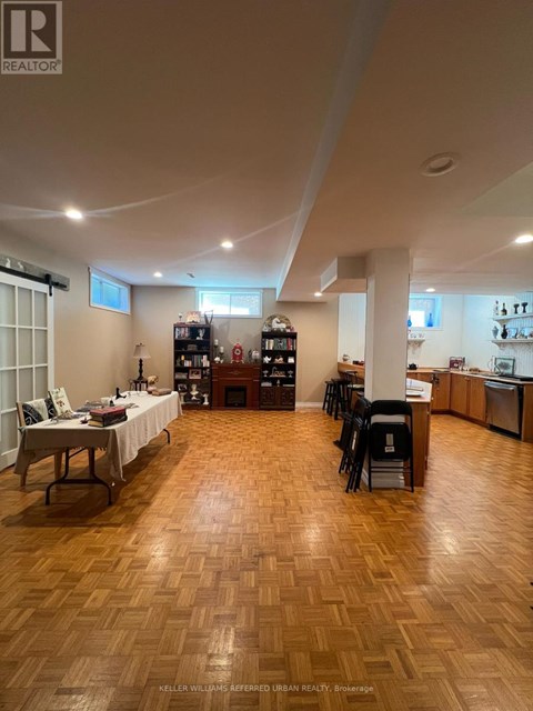 A living room with a wooden floor and furniture.