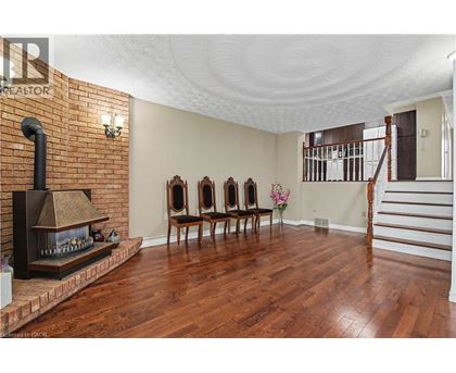 A living room with a fireplace and wood floors.