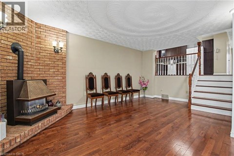 A living room with a fireplace and wood floors.