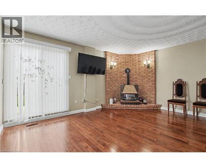 A living room with a fireplace and a flat screen TV.