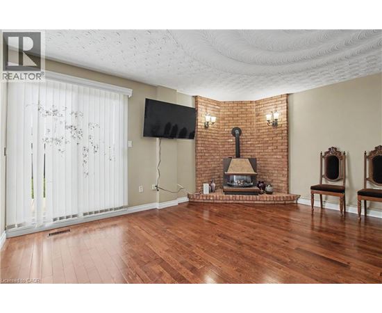 A living room with a fireplace and a flat screen TV.