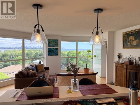 A well-lit living room with a laptop on the coffee table.