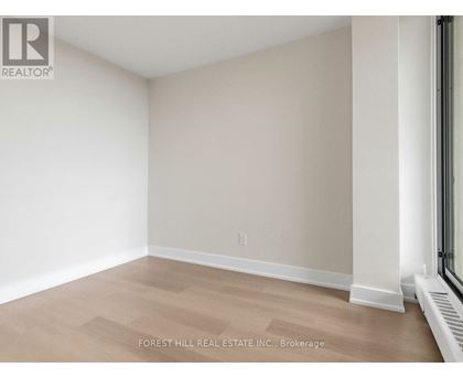 A room with a light brown floor and white walls.