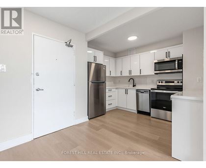 A kitchen with white cabinets and stainless steel appliances.