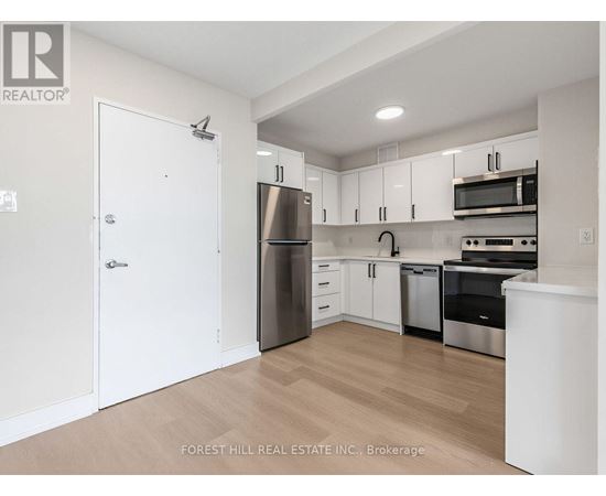 A kitchen with white cabinets and stainless steel appliances.
