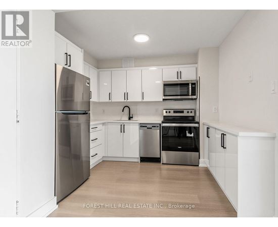 A kitchen with white cabinets and stainless steel appliances.